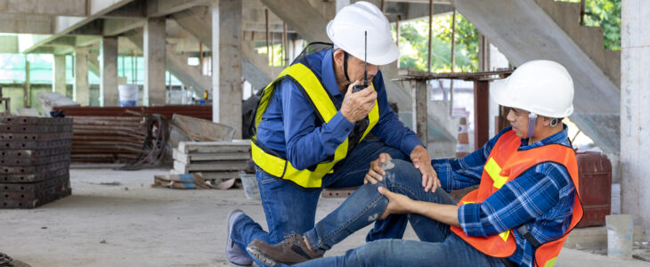 factory workers having accident while working in manufacturing site while his colleague is helping for safety workplace and emergency