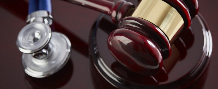 Gavel and Stethoscope on a wood table