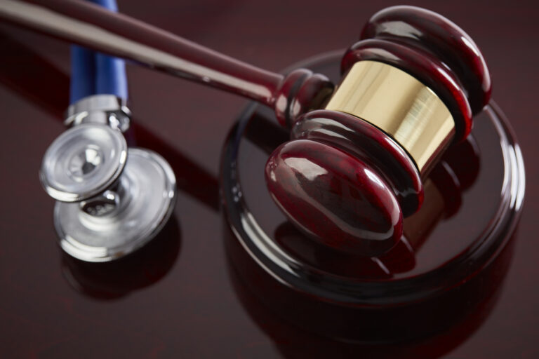 Gavel and Stethoscope on a wood table