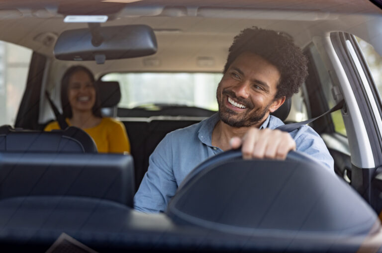 taxi driver talking to a female passenger