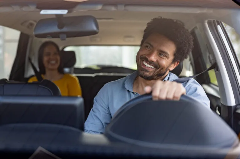 taxi driver talking to a female passenger
